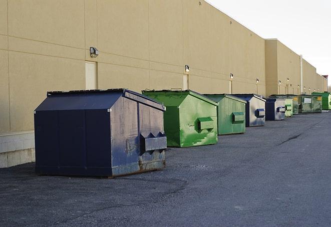 a collection of bright and vibrant dumpsters in a construction zone in Cardinal VA